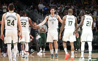 MILWAUKEE, WI - JULY 1: Brook Lopez #11 hi-fives Khris Middleton #22, P.J. Tucker #17, Pat Connaughton #24 and Jrue Holiday #21 of the Milwaukee Bucks during Game 5 of the Eastern Conference Finals of the 2021 NBA Playoffs on July 1, 2021 at the Fiserv Forum Center in Milwaukee, Wisconsin. NOTE TO USER: User expressly acknowledges and agrees that, by downloading and or using this Photograph, user is consenting to the terms and conditions of the Getty Images License Agreement. Mandatory Copyright Notice: Copyright 2021 NBAE (Photo by Gary Dineen/NBAE via Getty Images).