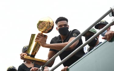 MILWAUKEE, WI - JULY 22: Giannis Antetokounmpo #34 of the Milwaukee Bucks holds the Larry O'Brien Trophy during their Victory Parade & Rally of the 2021 NBA Finals  on July 22, 2021 at the Fiserv Forum Center in Milwaukee, Wisconsin. NOTE TO USER: User expressly acknowledges and agrees that, by downloading and or using this Photograph, user is consenting to the terms and conditions of the Getty Images License Agreement. Mandatory Copyright Notice: Copyright 2021 NBAE (Photo by David Dow/NBAE via Getty Images). 