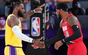 ORLANDO, FL - AUGUST 20: LeBron James #23 of the Los Angeles Lakers and Carmelo Anthony #00 of the Portland Trail Blazers high-five prior to a game during Round One, Game Two of the NBA Playoffs on August 20, 2020 at the AdventHealth Arena at ESPN Wide World Of Sports Complex in Orlando, Florida. NOTE TO USER: User expressly acknowledges and agrees that, by downloading and/or using this Photograph, user is consenting to the terms and conditions of the Getty Images License Agreement. Mandatory Copyright Notice: Copyright 2020 NBAE (Photo by Jesse D. Garrabrant/NBAE via Getty Images)