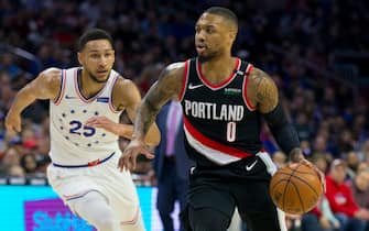 PHILADELPHIA, PA - FEBRUARY 23: Damian Lillard #0 of the Portland Trail Blazers dribbles the ball against Ben Simmons #25 of the Philadelphia 76ers in the first quarter at the Wells Fargo Center on February 23, 2019 in Philadelphia, Pennsylvania. NOTE TO USER: User expressly acknowledges and agrees that, by downloading and or using this photograph, User is consenting to the terms and conditions of the Getty Images License Agreement. (Photo by Mitchell Leff/Getty Images)