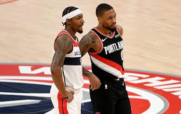 WASHINGTON, DC - FEBRUARY 02: Bradley Beal #3 of the Washington Wizards and Damian Lillard #0 of the Portland Trail Blazers look on during the first half at Capital One Arena on February 02, 2021 in Washington, DC. NOTE TO USER: User expressly acknowledges and agrees that, by downloading and or using this photograph, User is consenting to the terms and conditions of the Getty Images License Agreement. (Photo by Will Newton/Getty Images)