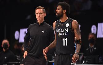 BROOKLYN, NY - JUNE 7: Head Coach Steve Nash of the Brooklyn Nets and Kyrie Irving #11 of the Brooklyn Nets look on during a game against the Milwaukee Bucks during Round 2, Game 2 on June 7, 2021 at Barclays Center in Brooklyn, New York. NOTE TO USER: User expressly acknowledges and agrees that, by downloading and/or using this Photograph, user is consenting to the terms and conditions of the Getty Images License Agreement. Mandatory Copyright Notice: Copyright 2021 NBAE (Photo by Jesse D. Garrabrant/NBAE via Getty Images) 