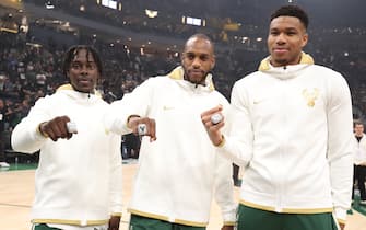 MILWAUKEE, WI - OCTOBER 19: Jrue Holiday #21, Khris Middleton #22, and Giannis Antetokounmpo #34 of the Milwaukee Bucks receive the 2021 NBA Championship ring before the game against the Brooklyn Nets on October 19, 2021 at the Fiserv Forum Center in Milwaukee, Wisconsin. NOTE TO USER: User expressly acknowledges and agrees that, by downloading and or using this Photograph, user is consenting to the terms and conditions of the Getty Images License Agreement. Mandatory Copyright Notice: Copyright 2021 NBAE (Photo by Nathaniel S. Butler/NBAE via Getty Images).