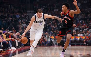 TORONTO, ON - OCTOBER 23: Luka Doncic #77 of the Dallas Mavericks drives against Scottie Barnes #4 of the Toronto Raptors during their NBA game at Scotiabank Arena on October 23, 2021 in Toronto, Canada. NOTE TO USER: User expressly acknowledges and agrees that, by downloading and or using this Photograph, user is consenting to the terms and conditions of the Getty Images License Agreement. (Photo by Cole Burston/Getty Images)