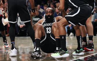 NEW YORK, NEW YORK - OCTOBER 27:  James Harden #13 of the Brooklyn Nets is helped to his feet after being knocked down driving to the basket against the Miami Heat during their game at Barclays Center on October 27, 2021 in New York City.  NOTE TO USER: User expressly acknowledges and agrees that, by downloading and or using this photograph, User is consenting to the terms and conditions of the Getty Images License Agreement. (Photo by Al Bello/Getty Images)