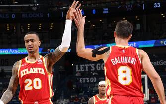 NEW ORLEANS, LA -OCTOBER 27: John Collins #20 high fives Danilo Gallinari #8 of the Atlanta Hawks during the game against the New Orleans Pelicans on October 27, 2021 at the Smoothie King Center in New Orleans, Louisiana. NOTE TO USER: User expressly acknowledges and agrees that, by downloading and or using this Photograph, user is consenting to the terms and conditions of the Getty Images License Agreement. Mandatory Copyright Notice: Copyright 2021 NBAE (Photo by Ned Dishman/NBAE via Getty Images)