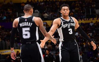 LOS ANGELES, CA - NOVEMBER 14: Dejounte Murray #5 and Keldon Johnson #3 of the San Antonio Spurs celebrate during the game against the Los Angeles Lakers on November 14, 2021 at STAPLES Center in Los Angeles, California. NOTE TO USER: User expressly acknowledges and agrees that, by downloading and/or using this Photograph, user is consenting to the terms and conditions of the Getty Images License Agreement. Mandatory Copyright Notice: Copyright 2021 NBAE (Photo by Adam Pantozzi/NBAE via Getty Images)