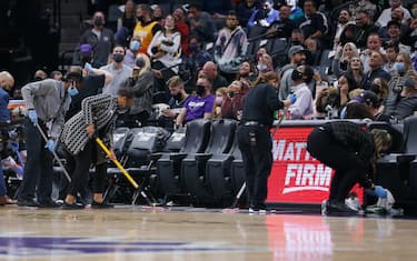SACRAMENTO, CALIFORNIA - NOVEMBER 20: Stadium staff clean the floor near the Utah Jazz bench after a fan was physically sick during in the fourth quarter of the game between the Sacramento Kings and the Utah Jazz at Golden 1 Center on November 20, 2021 in Sacramento, California. NOTE TO USER: User expressly acknowledges and agrees that, by downloading and/or using this photograph, User is consenting to the terms and conditions of the Getty Images License Agreement. (Photo by Lachlan Cunningham/Getty Images)