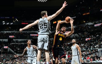SAN ANTONIO, TX - NOVEMBER 24: Jakob Poeltl #25 of the San Antonio Spurs blocks the shot by Danilo Gallinari #8 of the Atlanta Hawks on November 24, 2021 at AT&T Center in San Antonio, Texas. NOTE TO USER: User expressly acknowledges and agrees that, by downloading and or using this photograph, user is consenting to the terms and conditions of the Getty Images License Agreement. Mandatory Copyright Notice: Copyright 2021 NBAE (Photo by Michael Gonzales/NBAE via Getty Images)