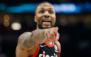 PORTLAND, OREGON - DECEMBER 14: Damian Lillard #0 of the Portland Trail Blazers reacts against the Phoenix Suns during the first quarter at Moda Center on December 14, 2021 in Portland, Oregon. NOTE TO USER: User expressly acknowledges and agrees that, by downloading and or using this photograph, User is consenting to the terms and conditions of the Getty Images License Agreement. (Photo by Steph Chambers/Getty Images)