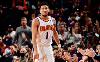 PHOENIX, AZ - DECEMBER 27: Devin Booker #1 of the Phoenix Suns looks on during the game against the Memphis Grizzlies on December 27, 2021 at Footprint Center in Phoenix, Arizona. NOTE TO USER: User expressly acknowledges and agrees that, by downloading and or using this photograph, user is consenting to the terms and conditions of the Getty Images License Agreement. Mandatory Copyright Notice: Copyright 2021 NBAE (Photo by Barry Gossage/NBAE via Getty Images)