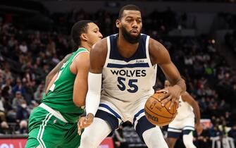 MINNEAPOLIS, MN - DECEMBER 27: Greg Monroe #55 of the Minnesota Timberwolves dribbles the ball against Grant Williams #12 of the Boston Celtics in the second quarter at Target Center on December 27, 2021 in Minneapolis, Minnesota. NOTE TO USER: User expressly acknowledges and agrees that, by downloading and or using this Photograph, user is consenting to the terms and conditions of the Getty Images License Agreement. (Photo by David Berding/Getty Images)