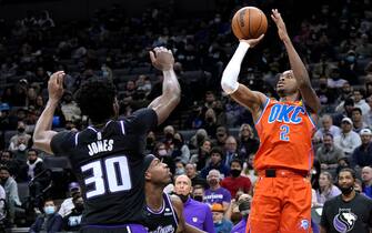 SACRAMENTO, CALIFORNIA - DECEMBER 28:  Shai Gilgeous-Alexander #2 of the Oklahoma City Thunder shoots over Damian Jones #30 of the Sacramento Kings during the third quarter at Golden 1 Center on December 28, 2021 in Sacramento, California. NOTE TO USER: User expressly acknowledges and agrees that, by downloading and or using this photograph, User is consenting to the terms and conditions of the Getty Images License Agreement. (Photo by Thearon W. Henderson/Getty Images)