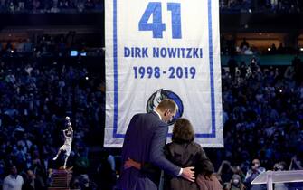 DALLAS, TEXAS - JANUARY 05: Former Dallas Mavericks player Dirk Nowitzki looks on with his wife, Jessica Olsson, as the Dallas Mavericks raise a banner while retiring his No. 41 jersey at American Airlines Center on January 05, 2022 in Dallas, Texas.  NOTE TO USER: User expressly acknowledges and agrees that, by downloading and or using this photograph, User is consenting to the terms and conditions of the Getty Images License Agreement. (Photo by Tom Pennington/Getty Images)
