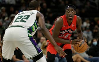 MILWAUKEE, WISCONSIN - JANUARY 05: Pascal Siakam #43 of the Toronto Raptors looks up at the clock while being guarded by Khris Middleton #22 of the Milwaukee Bucks during the second half at Fiserv Forum on January 05, 2022 in Milwaukee, Wisconsin. NOTE TO USER: User expressly acknowledges and agrees that, by downloading and or using this photograph, User is consenting to the terms and conditions of the Getty Images License Agreement. (Photo by John Fisher/Getty Images)