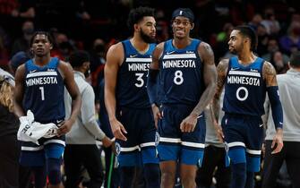 PORTLAND, OREGON - DECEMBER 12: (L-R) Anthony Edwards # 1, Karl-Anthony Towns # 32, Jarred Vanderbilt # 8, and D'Angelo Russell # 0 of the Minnesota Timberwolves walk back to the court after a timeout during the second half against the Portland Trail Blazers at Moda Center on December 12, 2021 in Portland, Oregon. NOTE TO USER: User expressly acknowledges and agrees that, by downloading and or using this photograph, User is consenting to the terms and conditions of the Getty Images License Agreement. (Photo by Soobum Im/Getty Images)