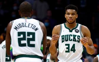 CHARLOTTE, NORTH CAROLINA - JANUARY 10: Giannis Antetokounmpo #34 of the Milwaukee Bucks reacts with teammate Khris Middleton #22 during the second half of the game against the Charlotte Hornets at Spectrum Center on January 10, 2022 in Charlotte, North Carolina. NOTE TO USER: User expressly acknowledges and agrees that, by downloading and or using this photograph, User is consenting to the terms and conditions of the Getty Images License Agreement. (Photo by Jared C. Tilton/Getty Images)