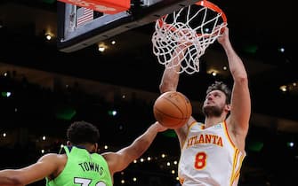 ATLANTA, GEORGIA - JANUARY 19:  Danilo Gallinari #8 of the Atlanta Hawks dunks against Karl-Anthony Towns #32 of the Minnesota Timberwolves during the second half at State Farm Arena on January 19, 2022 in Atlanta, Georgia.  NOTE TO USER: User expressly acknowledges and agrees that, by downloading and or using this photograph, User is consenting to the terms and conditions of the Getty Images License Agreement. (Photo by Kevin C. Cox/Getty Images)