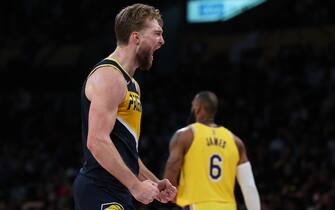 LOS ANGELES, CALIFORNIA - JANUARY 19: Domantas Sabonis #11 of the Indiana Pacers celebrates a lead as LeBron James #6 of the Los Angeles Lakers walks to the bench after a timeout during a 111-104 Pacers win at Crypto.com Arena on January 19, 2022 in Los Angeles, California. NOTE TO USER: User expressly acknowledges and agrees that, by downloading and/or using this Photograph, user is consenting to the terms and conditions of the Getty Images License Agreement. Mandatory Copyright Notice: Copyright 2022 NBAE (Photo by Harry How/Getty Images)
