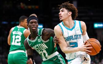 BOSTON, MA - JANUARY 19:  LaMelo Ball #2 of the Charlotte Hornets drives to the basket past Dennis Schroder #71 of the Boston Celtics during a game at TD Garden on January 19, 2022 in Boston, Massachusetts. NOTE TO USER: User expressly acknowledges and agrees that, by downloading and or using this photograph, User is consenting to the terms and conditions of the Getty Images License Agreement. (Photo by Adam Glanzman/Getty Images)