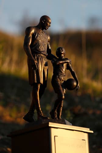 CALABASAS, CA  - JANUARY 26: A bronze sculpture of Kobe Bryant and Gianna Bryant by artist Dan Medina is on display on January 26, 2022 in Calabasas, California. The sculpture is a one-day, temporary memorial at the site of the tragic helicopter crash which killed a total of nine people, including Lakers star Kobe Bryant and his daughter Gianna on January 26, 2020. (Photo by Josh Lefkowitz/Getty Images)