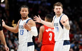 PORTLAND, OREGON - JANUARY 26: Jalen Brunson #13 and Luka Doncic #77 of the Dallas Mavericks react during the second quarter against the Portland Trail Blazers at Moda Center on January 26, 2022 in Portland, Oregon. NOTE TO USER: User expressly acknowledges and agrees that, by downloading and/or using this photograph, User is consenting to the terms and conditions of the Getty Images License Agreement. (Photo by Steph Chambers/Getty Images)