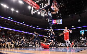 MEMPHIS, TENNESSEE - JANUARY 29: Ja Morant #12 of the Memphis Grizzlies dunks against Bradley Beal #3 of the Washington Wizards during the second half at FedExForum on January 29, 2022 in Memphis, Tennessee. NOTE TO USER: User expressly acknowledges and agrees that, by downloading and or using this photograph, User is consenting to the terms and conditions of the Getty Images License Agreement. (Photo by Justin Ford/Getty Images)