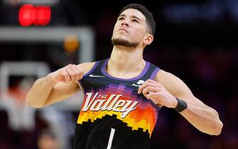 PHOENIX, ARIZONA - FEBRUARY 01:  Devin Booker #1 of the Phoenix Suns adjusts his jersey during the second half of the NBA game against the Brooklyn Nets at Footprint Center on February 01, 2022 in Phoenix, Arizona. The Suns defeated the Nets 121-111. NOTE TO USER: User expressly acknowledges and agrees that, by downloading and or using this photograph, User is consenting to the terms and conditions of the Getty Images License Agreement. (Photo by Christian Petersen/Getty Images)