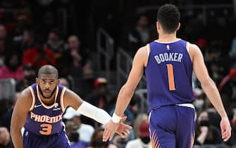 ATLANTA, GA - FEBRUARY 3: Chris Paul #3 hi-fives Devin Booker #1 of the Phoenix Suns during the game against the Atlanta Hawks on February 3, 2022 at State Farm Arena in Atlanta, Georgia.  NOTE TO USER: User expressly acknowledges and agrees that, by downloading and/or using this Photograph, user is consenting to the terms and conditions of the Getty Images License Agreement. Mandatory Copyright Notice: Copyright 2022 NBAE (Photo by Adam Hagy/NBAE via Getty Images)