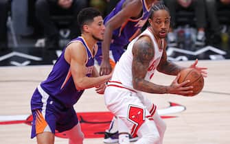 CHICAGO, IL - FEBRUARY 07: Phoenix Suns Guard Devin Booker (1) posts up against Chicago Bulls Forward DeMar DeRozan (11) during a NBA game between the Phoenix Suns and the Chicago Bulls on February 7, 2022 at the United Center in Chicago, IL. (Photo by Melissa Tamez/Icon Sportswire via Getty Images)