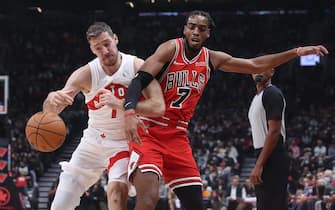 Toronto, ON- October 25  -  Toronto Raptors guard Goran Dragic (1) and Chicago Bulls forward Troy Brown Jr. (7) battle for a ball as the Toronto Raptors play the Chicago Bulls at Scotiabank Arena in Toronto. October 25, 2021.        (Steve Russell/Toronto Star via Getty Images)