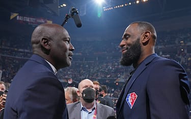 CLEVELAND, OH - FEBRUARY 20: NBA Legends, Michael Jordan and LeBron James shake hands during the 2022 NBA All-Star Game as part of 2022 NBA All Star Weekend on February 20, 2022 at Rocket Mortgage FieldHouse in Cleveland, Ohio. NOTE TO USER: User expressly acknowledges and agrees that, by downloading and/or using this Photograph, user is consenting to the terms and conditions of the Getty Images License Agreement. Mandatory Copyright Notice: Copyright 2022 NBAE (Photo by Jesse D. Garrabrant/NBAE via Getty Images)