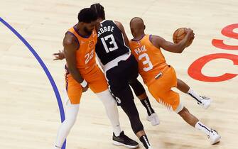 LOS ANGELES, CA - JUNE 24: Chris Paul #3 of the Phoenix Suns drives past Paul George #13 of the LA Clippers on a screen set by Deandre Ayton #22 of the Phoenix Suns during Game 3 of the Western Conference Finals of the 2021 NBA Playoffs on June 24, 2021 at STAPLES Center  Los Angeles, CA. NOTE TO USER: User expressly acknowledges and agrees that, by downloading and or using this photograph, User is consenting to the terms and conditions of the Getty Images License Agreement. Mandatory Credit: 2021 NBAE (Photo by Chris Elise/NBAE via Getty Images)