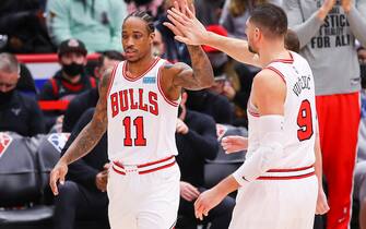 CHICAGO, IL - JANUARY 14: Chicago Bulls Forward DeMar DeRozan (11) high fives teammate Chicago Bulls Center Nikola Vucevic (9) during a NBA game between the Golden State Warriors and the Chicago Bulls on January 14, 2022 at the United Center in Chicago, IL. (Photo by Melissa Tamez/Icon Sportswire via Getty Images)