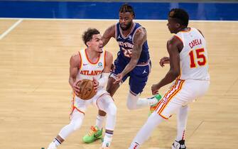 NEW YORK, NY - JUNE 02:   Trae Young #11 of the Atlanta Hawks looks to drive past Reggie Bullock #25 of the New York Knicks on a screen by Clint Capela #15 in the fourth quarter during Game Five of the Eastern Conference first round series at Madison Square Garden on June 02, 2021 in New York City. NOTE TO USER: User expressly acknowledges and agrees that, by downloading and or using this photograph, User is consenting to the terms and conditions of the Getty Images License Agreement.  (Photo by Wendell Cruz-Pool/Getty Images)