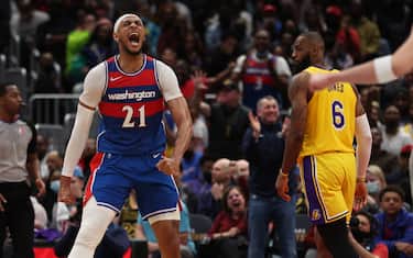 WASHINGTON, DC - MARCH 19: Daniel Gafford #21 of the Washington Wizards celebrates in front of LeBron James #6 of the Los Angeles Lakers during the second half at Capital One Arena on March 19, 2022 in Washington, DC. NOTE TO USER: User expressly acknowledges and agrees that, by downloading and or using this photograph, User is consenting to the terms and conditions of the Getty Images License Agreement. (Photo by Patrick Smith/Getty Images)