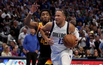 DALLAS, TEXAS - APRIL 18: Jalen Brunson #13 of the Dallas Mavericks drives to the basket against Donovan Mitchell #45 of the Utah Jazz in the fourth quarter of Game Two of the Western Conference First Round NBA Playoffs at American Airlines Center on April 18, 2022 in Dallas, Texas. NOTE TO USER: User expressly acknowledges and agrees that, by downloading and or using this photograph, User is consenting to the terms and conditions of the Getty Images License Agreement. (Photo by Tom Pennington/Getty Images)