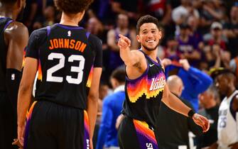 PHOENIX, AZ - MAY 10: Cameron Johnson #23 of the Phoenix Suns talks with Devin Booker #1 during Game 5 of the 2022 NBA Playoffs Western Conference Semifinals on May 10, 2022 at Footprint Center in Phoenix, Arizona. NOTE TO USER: User expressly acknowledges and agrees that, by downloading and or using this photograph, user is consenting to the terms and conditions of the Getty Images License Agreement. Mandatory Copyright Notice: Copyright 2022 NBAE (Photo by Barry Gossage/NBAE via Getty Images)