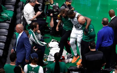 BOSTON, MASSACHUSETTS - MAY 21: Marcus Smart #36 of the Boston Celtics is helped off the court in the third quarter against the Miami Heat in Game Three of the 2022 NBA Playoffs Eastern Conference Finals at TD Garden on May 21, 2022 in Boston, Massachusetts. NOTE TO USER: User expressly acknowledges and agrees that, by downloading and/or using this photograph, User is consenting to the terms and conditions of the Getty Images License Agreement.  (Photo by Winslow Townson/Getty Images)