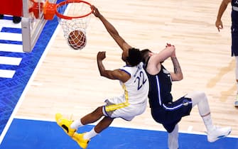 DALLAS, TEXAS - MAY 22: Andrew Wiggins #22 of the Golden State Warriors dunks the ball against Luka Doncic #77 of the Dallas Mavericks during the fourth quarter in Game Three of the 2022 NBA Playoffs Western Conference Finals at American Airlines Center on May 22, 2022 in Dallas, Texas. NOTE TO USER: User expressly acknowledges and agrees that, by downloading and or using this photograph, User is consenting to the terms and conditions of the Getty Images License Agreement. (Photo by Ron Jenkins/Getty Images)