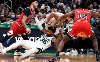 1236294379 Boston - November 1: The Celtics Marcus Smart ends up on the floor as he and teammate Jayson Tatum battle with the Bulls Lonzo Ball and Ayo Dosunmu, as Celtics head coach Ime Udoka looks on at far right. The Boston Celtics hosted the Chicago Bulls in a regular season NBA basketball game at the TD Garden in Boston on Nov. 1, 2021. (Photo by Jim Davis/The Boston Globe via Getty Images)