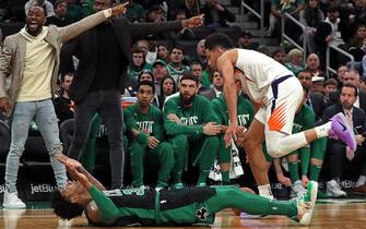 BOSTON, MA - JANUARY 18: Boston Celtics guard Kemba Walker and Boston Celtics guard Jaylen Brown, both of whom sat on the bench during the game, signal that Boston Celtics guard Marcus Smart (36) took a charge from Phoenix Suns guard Devin Booker (1) during the first quarter. The Boston Celtics host the Phoenix Suns at TD Garden in Boston on Jan. 18, 2020. (Photo by Barry Chin/The Boston Globe via Getty Images)