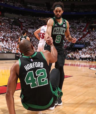 MIAMI, FL - MAY 25: Derrick White #9 of the Boston Celtics helps up Al Horford #42 of the Boston Celtics during Game 5 of the 2022 NBA Playoffs Eastern Conference Finals on May 25, 2022 at FTX Arena in Miami, Florida. NOTE TO USER: User expressly acknowledges and agrees that, by downloading and or using this Photograph, user is consenting to the terms and conditions of the Getty Images License Agreement. Mandatory Copyright Notice: Copyright 2022 NBAE (Photo by Issac Baldizon/NBAE via Getty Images)