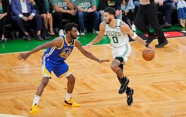BOSTON, MA - JUNE 16: Jayson Tatum #0 of the Boston Celtics dribbles the ball against Andrew Wiggins #22 of the Golden State Warriors during Game Six of the 2022 NBA Finals on June 16, 2022 at TD Garden in Boston, Massachusetts. NOTE TO USER: User expressly acknowledges and agrees that, by downloading and or using this photograph, user is consenting to the terms and conditions of Getty Images License Agreement. Mandatory Copyright Notice: Copyright 2022 NBAE (Photo by Mark Blinch/NBAE via Getty Images)