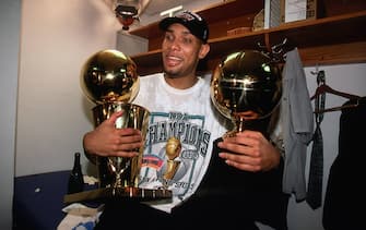 NEW YORK - JUNE 25:  Tim Duncan #21 of the San Antonio Spurs holds both the Larry O'Brien trophy and MVP Trophy in his lap following Game Five of the 1999 NBA Finals at Madison Square Garden on June 25, 1999 in New York, New York.   NOTE TO USER: User expressly acknowledges that, by downloading and or using this photograph, User is consenting to the terms and conditions of the Getty Images License agreement. Mandatory Copyright Notice: Copyright 1999 NBAE (Photo by Nathaniel S. Butler/NBAE via Getty Images)