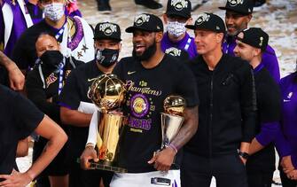 LAKE BUENA VISTA, FLORIDA - OCTOBER 11: LeBron James #23 of the Los Angeles Lakers reacts with his MVP trophy and Finals trophy after winning the 2020 NBA Championship over the Miami Heat in Game Six of the 2020 NBA Finals at AdventHealth Arena at the ESPN Wide World Of Sports Complex on October 11, 2020 in Lake Buena Vista, Florida. NOTE TO USER: User expressly acknowledges and agrees that, by downloading and or using this photograph, User is consenting to the terms and conditions of the Getty Images License Agreement.  (Photo by Mike Ehrmann/Getty Images)