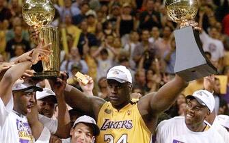 LOS ANGELES, UNITED STATES:  Shaquille O'Neal of the Los Angeles Lakers holds the MVP trophy and the Larry O'Brien Trophy for winning the NBA Championship 19 June, 2000, after game six of the NBA Finals at Staples Center in Los Angeles, CA. The Lakers won the game against the Indiana Pacers 116-111 to take the NBA title 4-2 in the best-of-seven series. O'Neal scored 41 points and was named the Most Valuble Player for the championship series.  (ELECTRONIC IMAGE)  AFP PHOTO/Vince BUCCI (Photo credit should read Vince Bucci/AFP via Getty Images)
