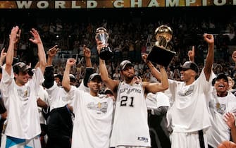 SAN ANTONIO - JUNE 23: Finals MVP Tim Duncan (C) #21 of the San Antonio Spurs celebrates with the MVP Tophy in his left and the Larry O'Brien NBA Championship trophy with teammate Manu Ginobili #20 (L), Tony Parker #9 (2nd L) and Bruce Bowen #12 following their 81-74 win against the Detroit Pistons in Game Seven of the 2005 NBA Finals on June 23, 2005 at SBC Center in San Antonio. NOTE TO USER: User expressly acknowledges and agrees that, by downloading and or using this photograph, User is consenting to the terms and conditions of the Getty Images License Agreement. Mandatory Copyright Notice: Copyright 2005 NBAE (Photo by Nathaniel S. Butler/NBAE via Getty Images)