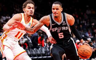 ATLANTA, GA - FEBRUARY 11: Dejounte Murray #5 of the San Antonio Spurs drives the ball past Trae Young #11 of the Atlanta Hawks during the first half of a game at State Farm Arena on February 11, 2022 in Atlanta, Georgia. NOTE TO USER: User expressly acknowledges and agrees that, by downloading and or using this photograph, User is consenting to the terms and conditions of the Getty Images License Agreement. (Photo by Casey Sykes/Getty Images)