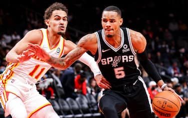 ATLANTA, GA - FEBRUARY 11: Dejounte Murray #5 of the San Antonio Spurs drives the ball past Trae Young #11 of the Atlanta Hawks during the first half of a game at State Farm Arena on February 11, 2022 in Atlanta, Georgia. NOTE TO USER: User expressly acknowledges and agrees that, by downloading and or using this photograph, User is consenting to the terms and conditions of the Getty Images License Agreement. (Photo by Casey Sykes/Getty Images)
